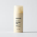 Cream-colored cylindrical bottle of Versed Weekend Glow Brightening Serum with black text label, 1 FL OZ.